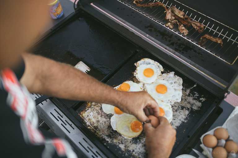 cracking eggs onto bbq plate