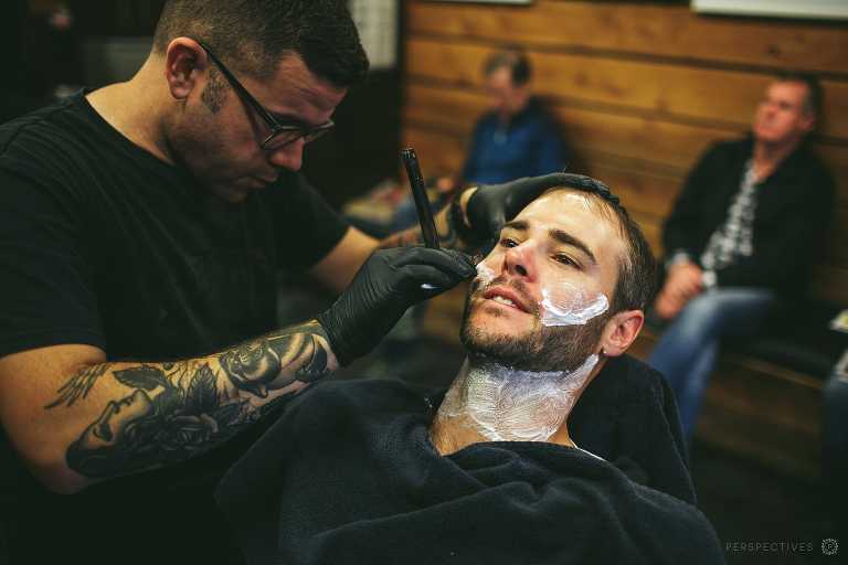 groom having cut throat shave on wedding day