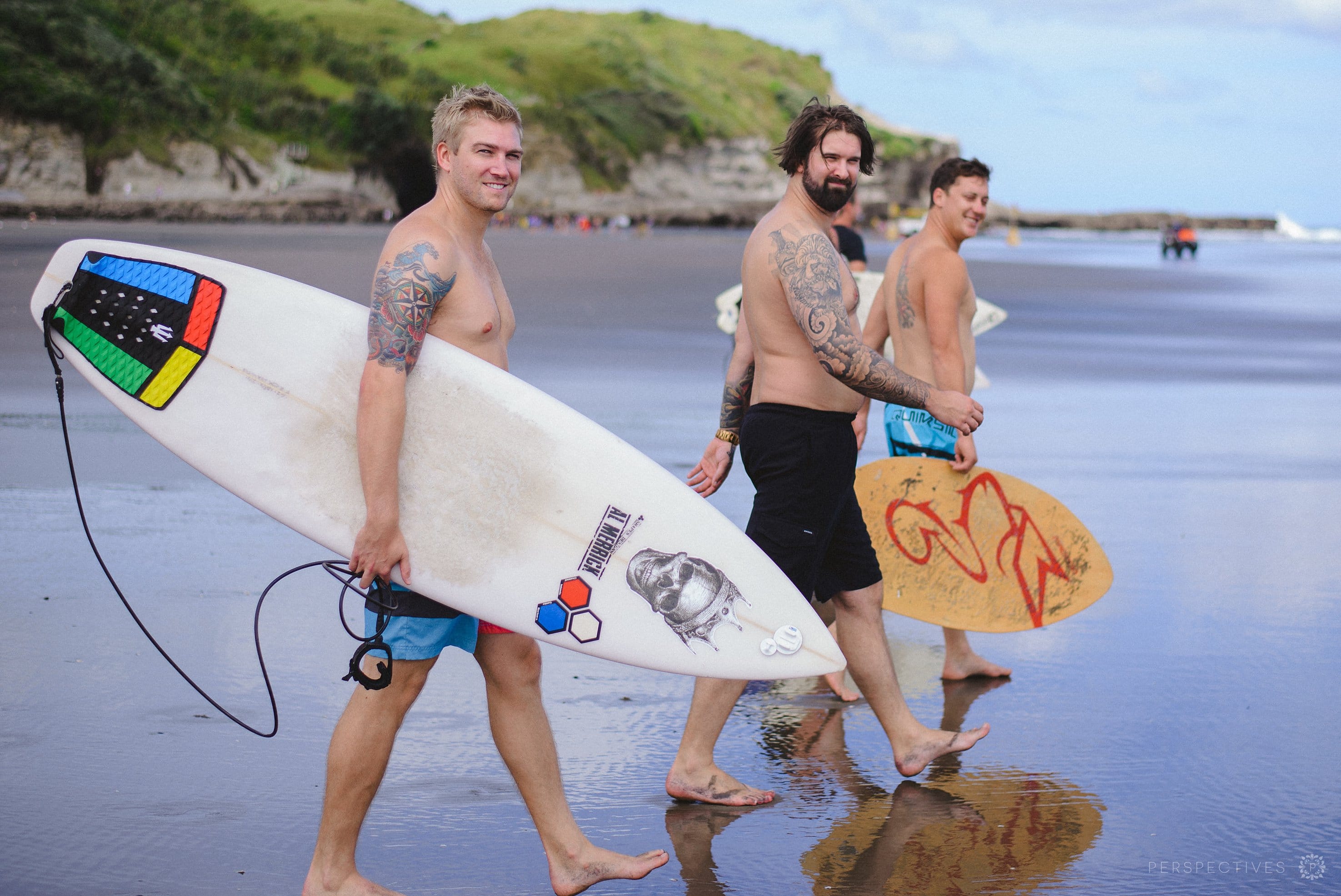 guys carrying surfboards