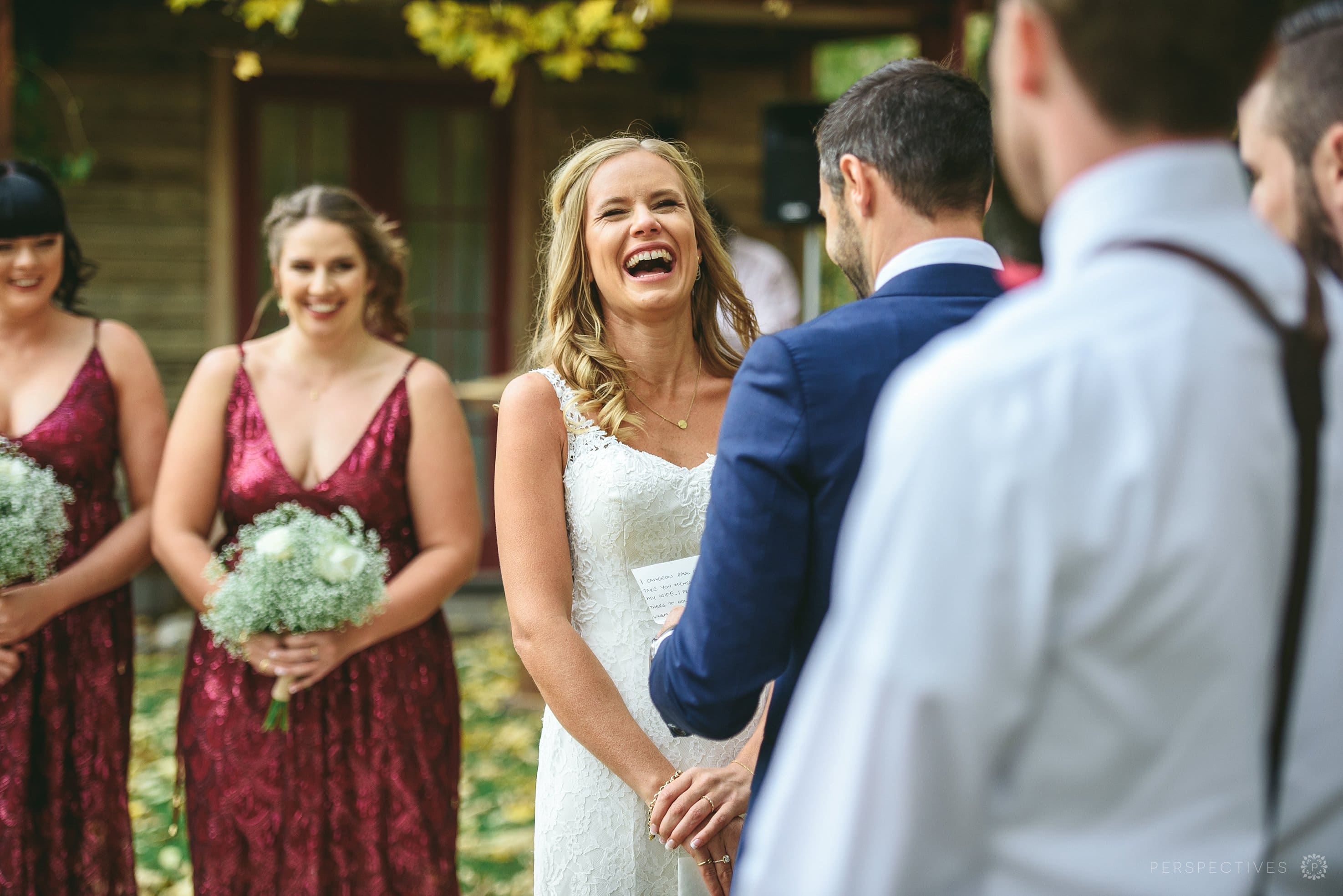 bride laughs in wedding ceremony