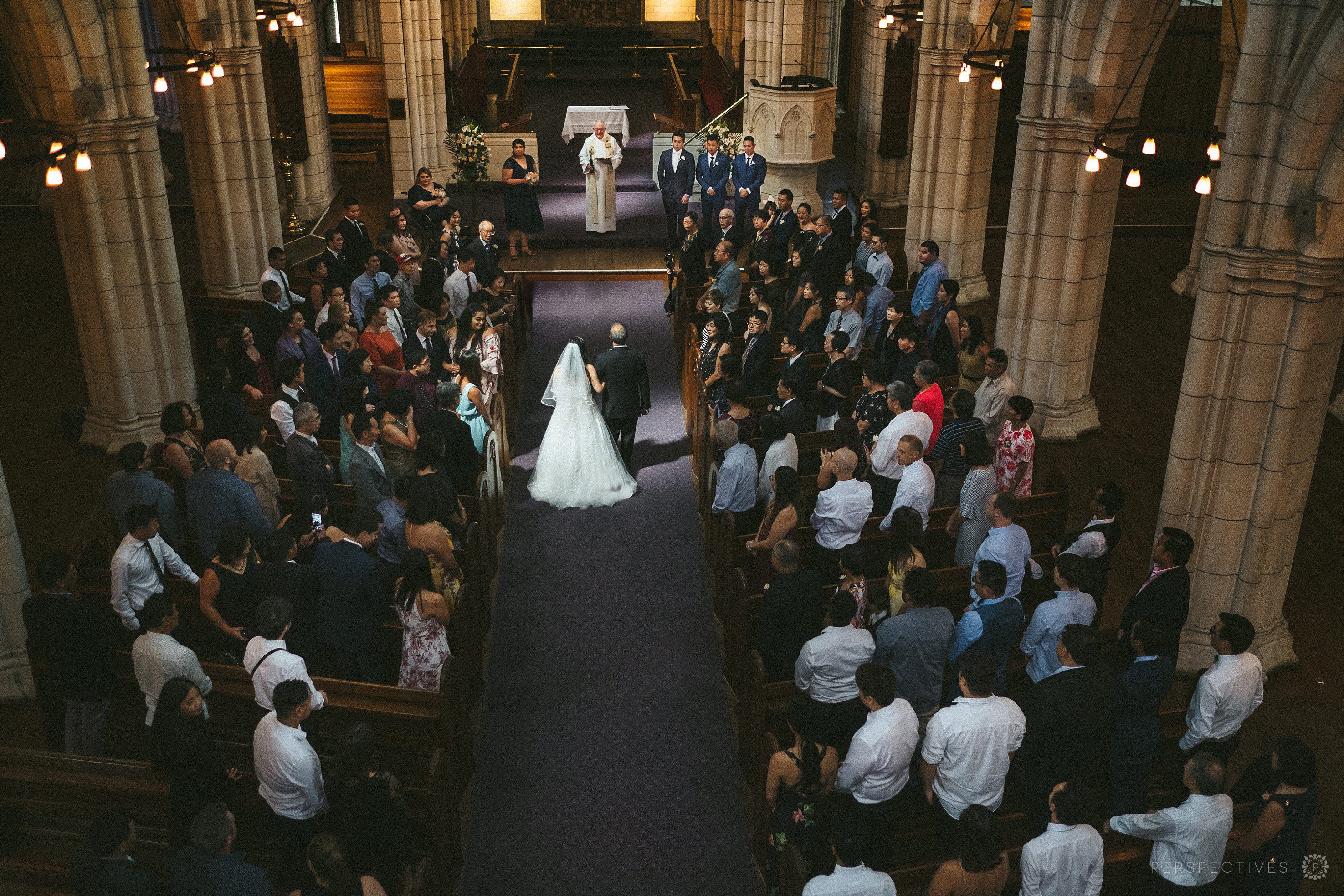 bride enters church in wedding ceremony from above
