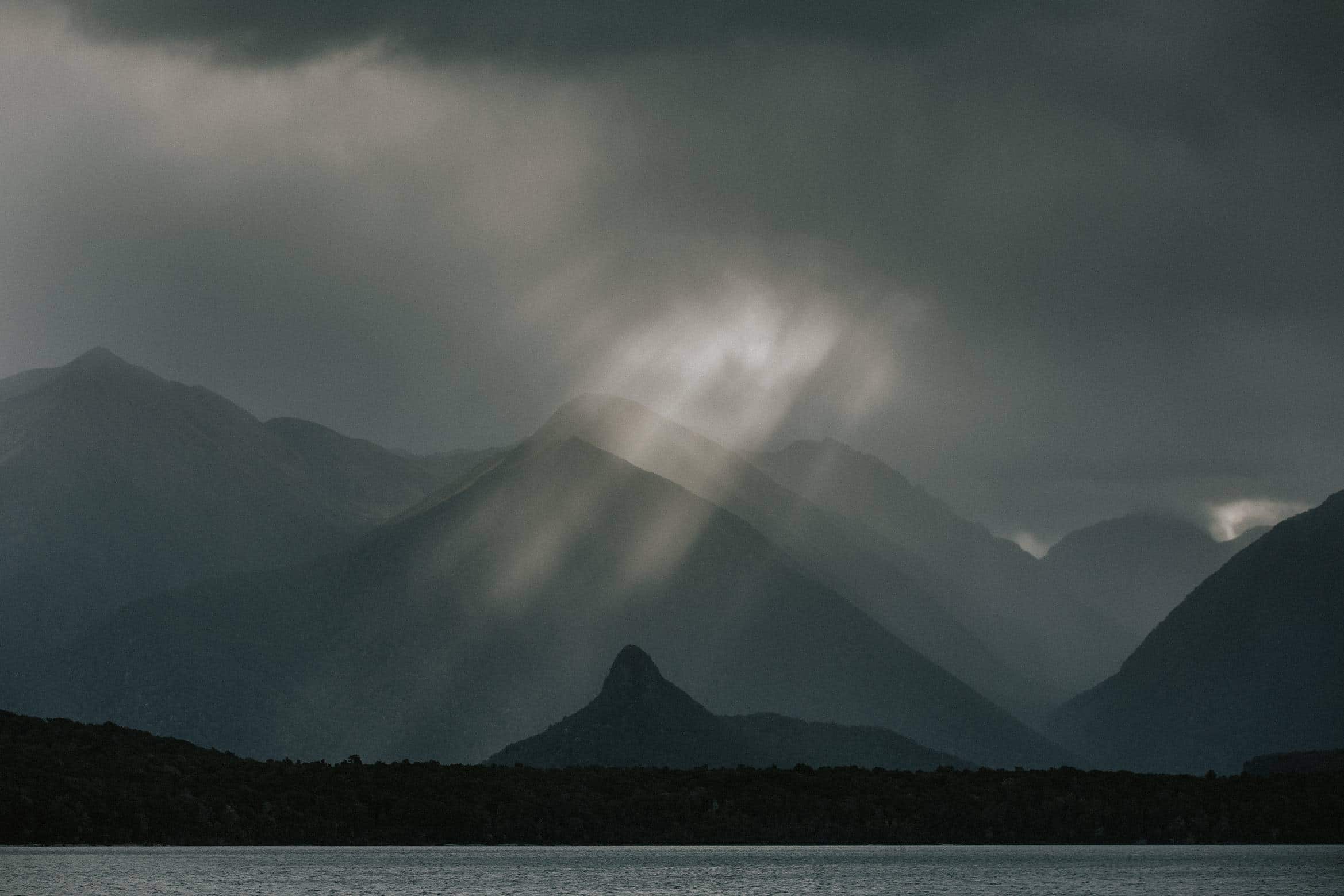 rays of sun through the clouds above manapouri