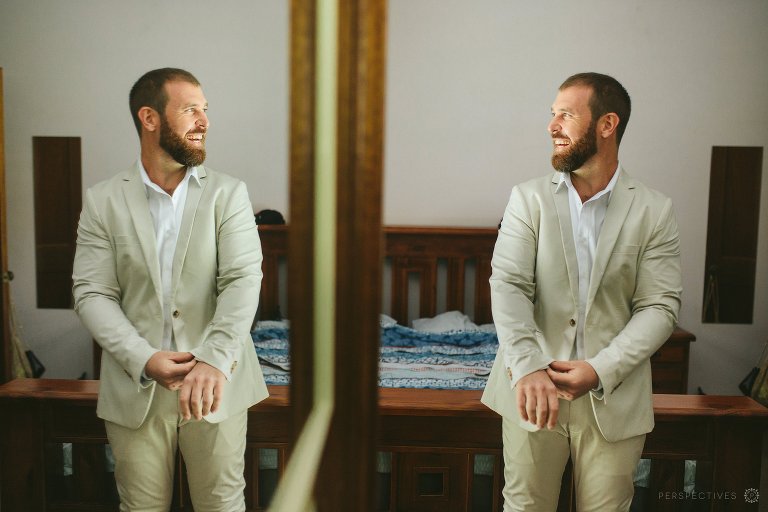 Cairns wedding photographer - groom getting dressed