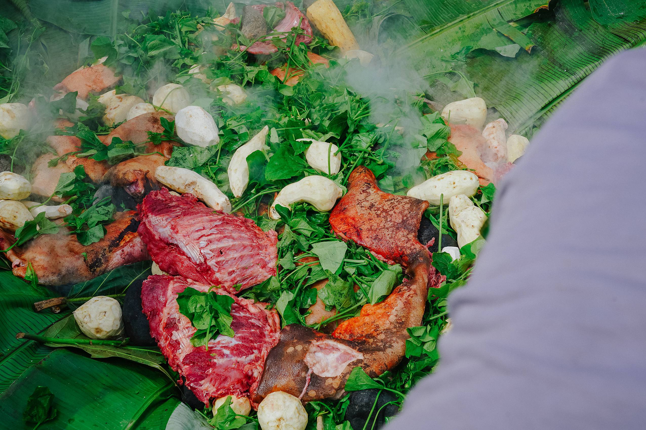 Preparing pig feast Mumu Papua New Guinea