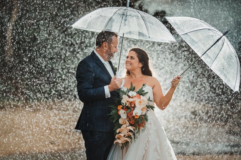 Palm Cove rainy wedding photo with umbrellas in rain