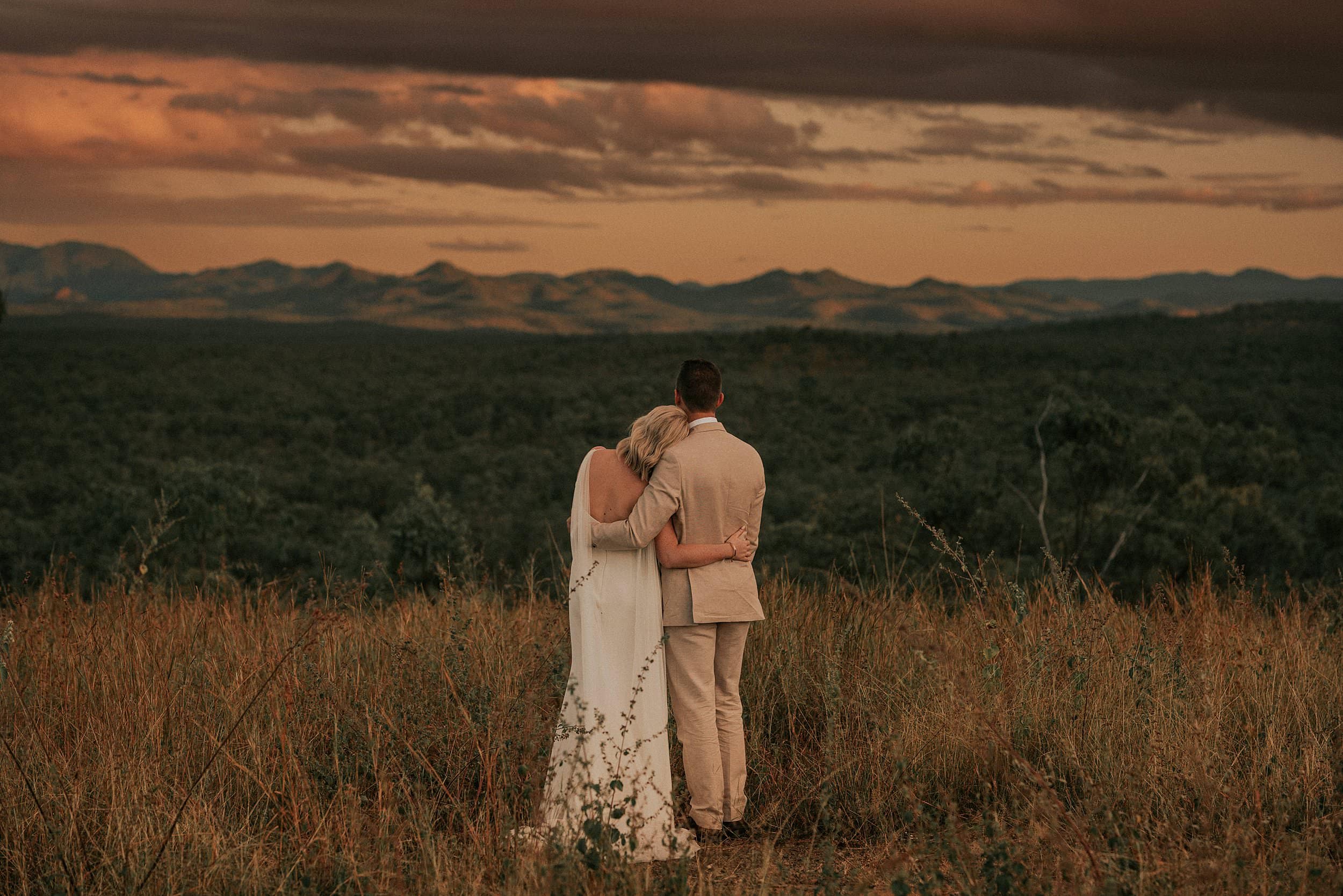 Wedding couple looking over the valley at Mount Mulligan
