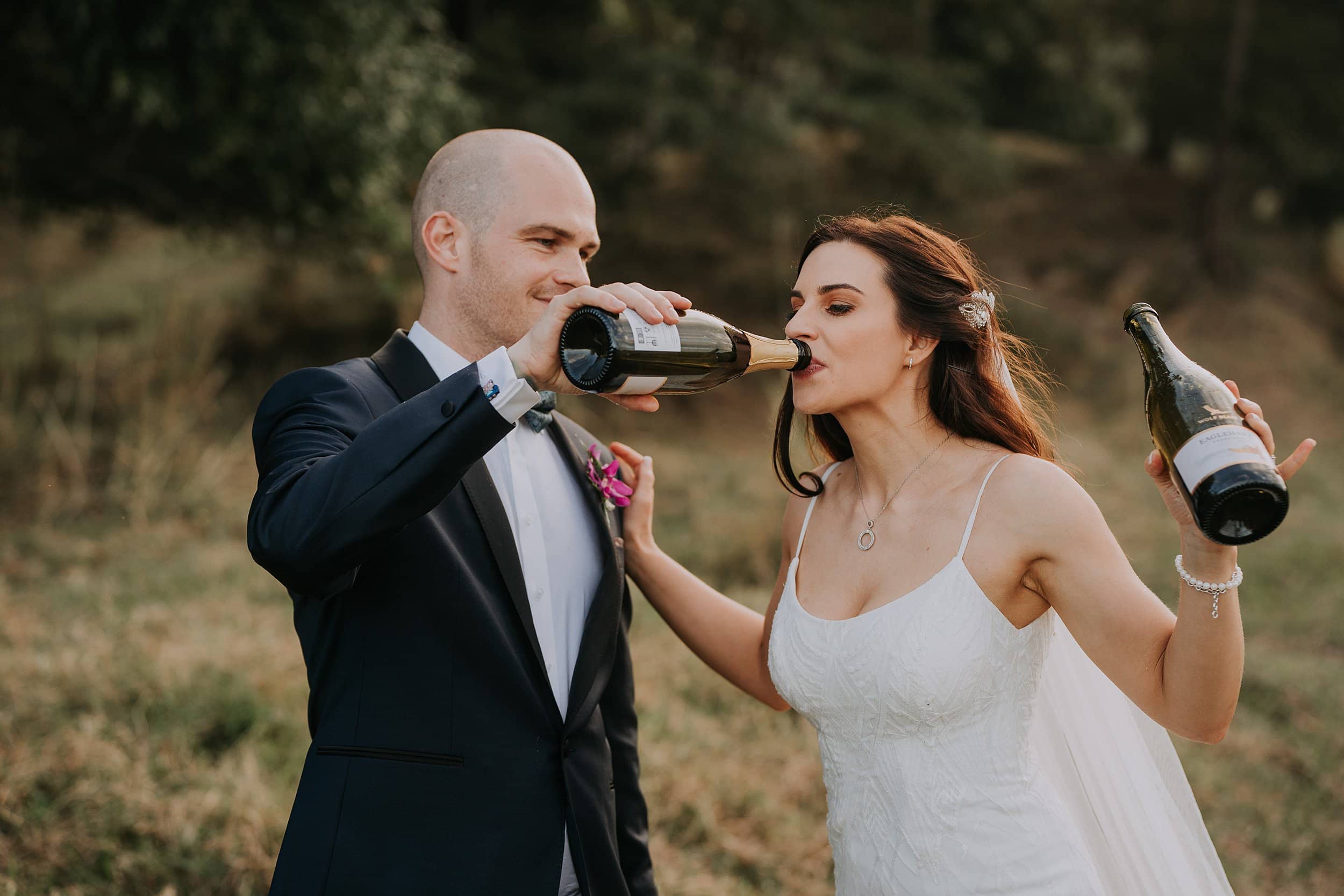 Bride and groom drink champagne on wedding day
