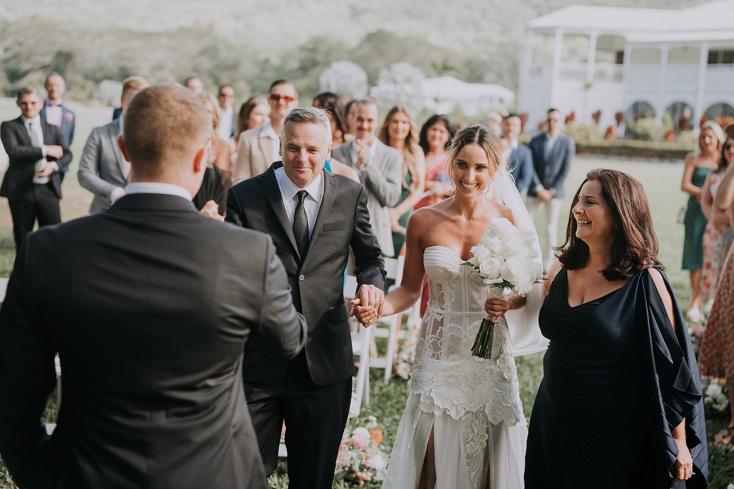 Parents of bride escort her down aisle