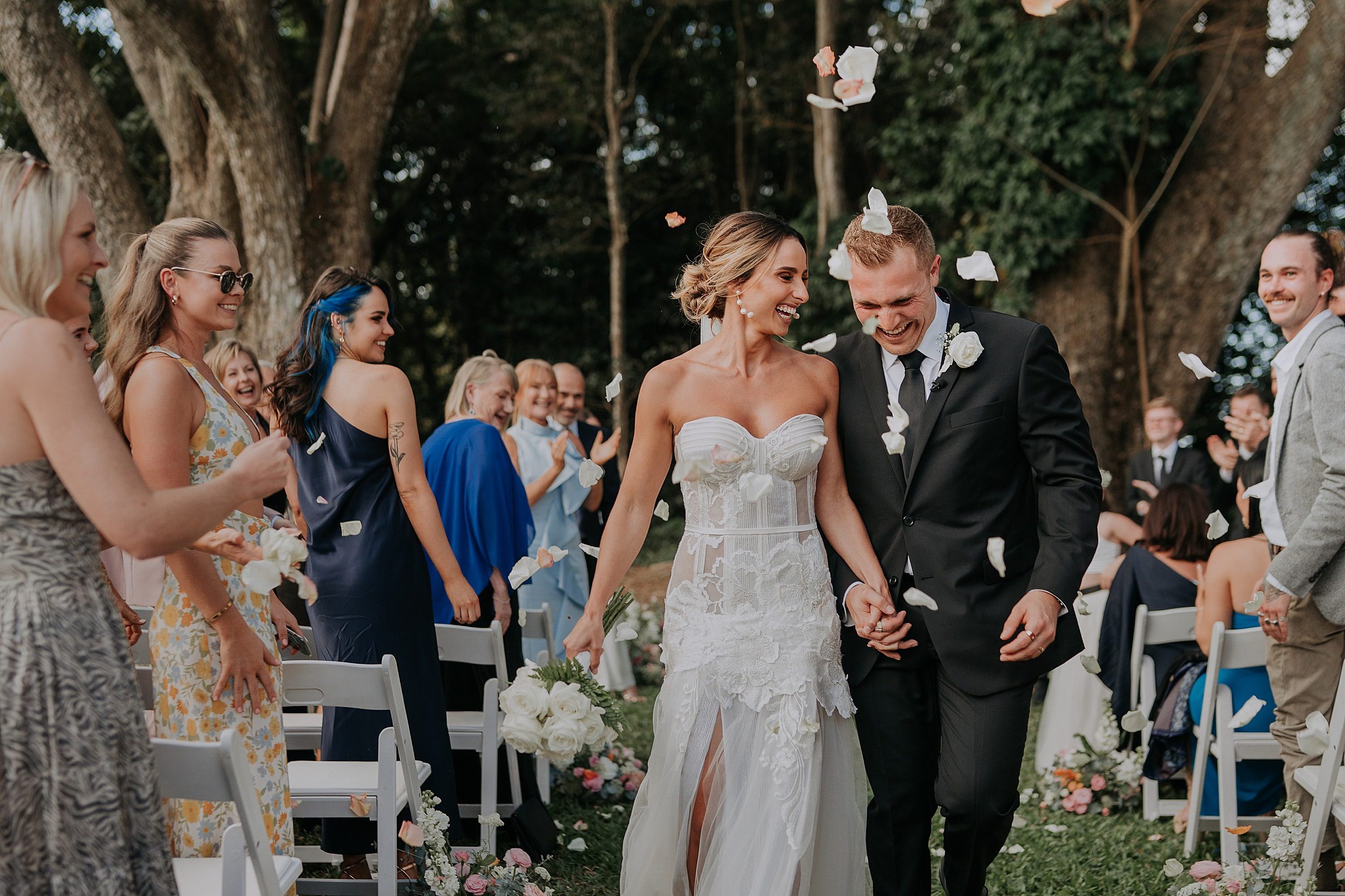 Walking back up aisle post ceremony with confetti at Lakeside Retreat