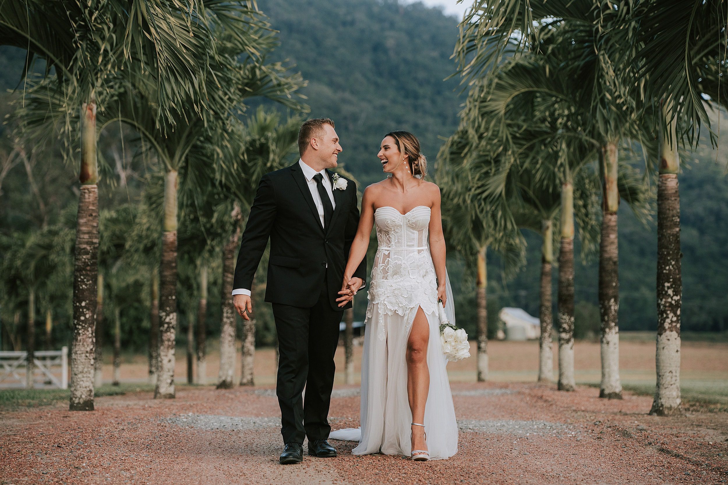 Driveway at Lakeside Retreat in Mowbray - with palm trees and bride + groom walking